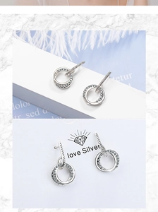 Detail of silver hoop earrings with white zircon stones on display card and elegant setting