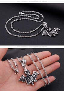 Detail showing vintage punk silver stainless steel bat skull pendant with wing motif