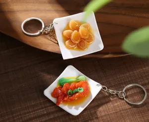 Macro shot of realistic artificial food keychains on a white plate over a wooden tray