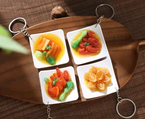 Close-up of realistic miniature food keychains with Chinese dishes on a wooden tray
