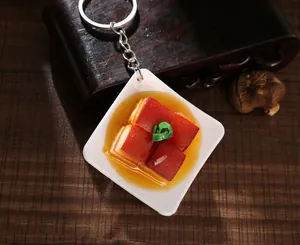 Macro shot of realistic braised pork keychain pendant with soy sauce glaze and scallions