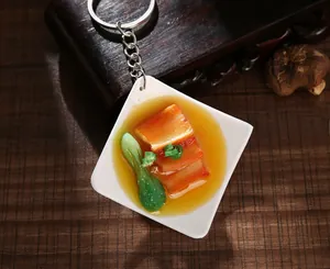 Detailed macro view of a realistic braised pork and vegetable food keychain pendant