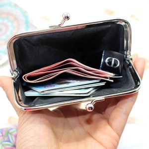 Ethnic geometric pattern coin purse with metal clasp holding cards and lipstick