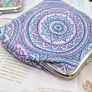 Detailed close-up of mandala pattern bohemian coin purse with silver metal kiss lock closure