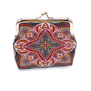 Detailed view of bohemian floral coin purse with vintage metal clasp closure