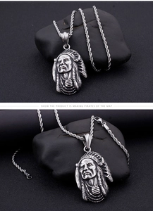 Close-up of silver Indian chief portrait pendant on twisted chain over black stone