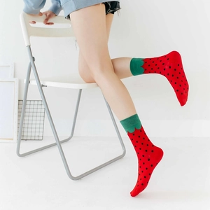 Detail of red strawberry pattern mid-calf cotton socks with green scalloped edges