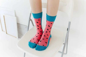 Detailed view of pink cotton crew socks featuring watermelon patterns and blue trim