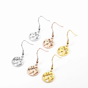 Detailed close-up of hollow world map earrings in silver, gold, and rose gold finishes