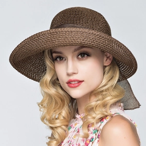 Elegant brown woven straw sun hat with wide brim and decorative ribbon for summer beach use