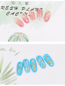 Detailed view of pink heart and blue ocean theme nail charms with golden metal studs