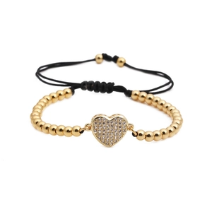 Bracelet à perles dorées avec breloque cœur sertie de zircons et cordon noir ajustable