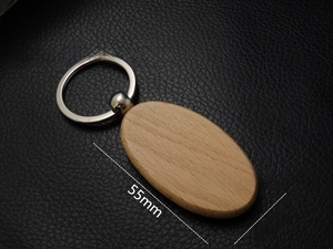 Macro detail of oval beech wood keychain with measurements of 55mm by 31mm
