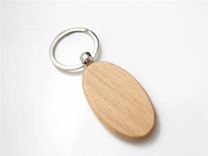 Detailed close-up of oval beech wood keychain with silver rotating metal ring on white