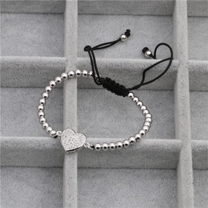 Détail du bracelet avec pendentif cœur en zircone et perles sur cordon noir ajustable