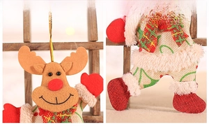 Detail of Christmas reindeer ornament with burlap body and red plaid scarf accessory