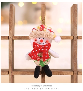 Detail of plush Christmas snowman ornament with burlap vest and gold hanging string