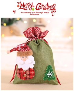 Detail of green burlap Christmas gift bag with 3D Santa Claus and sequined tree decor