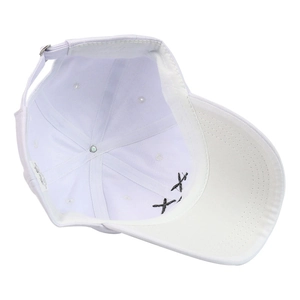 Detail of white cotton baseball cap showing interior stitching and silver metal buckle