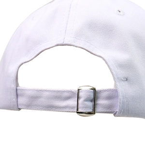 Close-up of white cotton baseball cap with adjustable silver metal buckle at the back