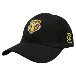 Close-up of the detailed tiger head embroidery and yellow side logo on a black baseball cap