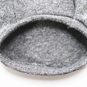 Close-up of thick grey fleece lining and knitted texture on dog winter hoodie