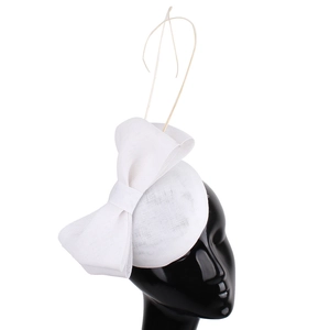 Elegant white fascinator hat with mesh bow and feather detail on a black mannequin head