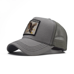 Close-up of eagle embroidery patch with FREEDOM text on grey and green trucker hat