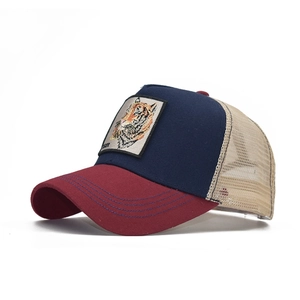 Detail of tiger embroidery on a tri-color mesh trucker cap with navy and burgundy panels