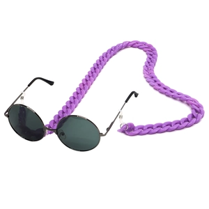 Detailed view of purple acrylic eyeglass chain paired with black round metal sunglasses