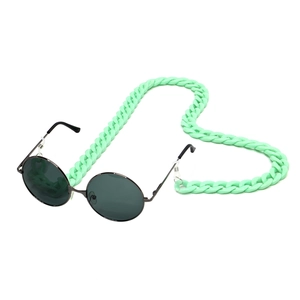 Close-up of mint green acrylic chunky chain attached to retro round sunglasses