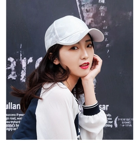 Close-up of white camo jacquard baseball cap showing breathable mesh texture on model