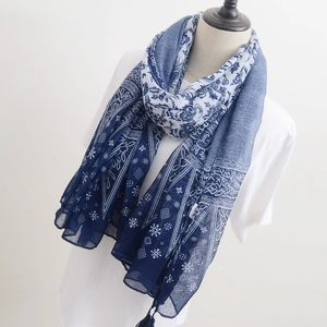 Detail of blue and white floral porcelain print scarf with elegant tassel decorative fringe