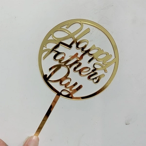Golden mirror acrylic cake topper featuring Happy Father's Day text being held by hand