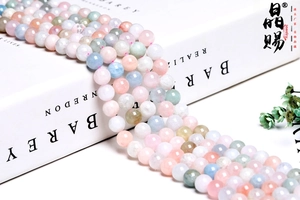 Macro detail of natural multi-colored Morganite round beads on minimalist white book