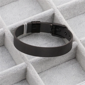 Detail of black mesh stainless steel strap with adjustable buckle in a jewelry box