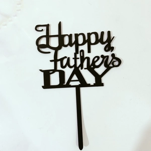 Detail of Happy Fathers Day black acrylic cake topper with elegant typography design