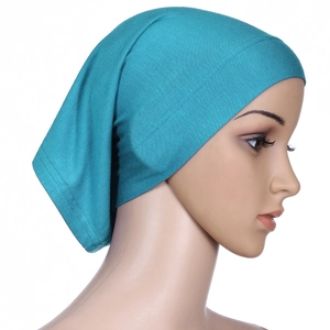 Side view of teal mercerized cotton underscarf tube cap on mannequin head