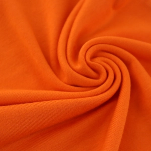 Macro shot showing the texture and soft folds of the orange mercerized cotton fabric