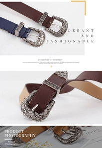 Détail d'une boucle de ceinture style western rétro avec gravure florale et sangle en cuir