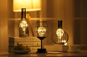 Three Nordic iron wine bottle lamps with warm copper wire lights for home decor