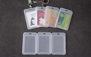 Flat lay of transparent plastic card holders with metal hooks for ID and bus cards