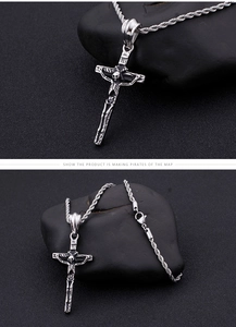 Detail view of silver skull cross pendant and twisted rope chain for men