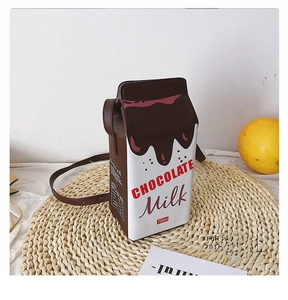 Detail shot of creative milk carton shaped shoulder bag with chocolate milk design