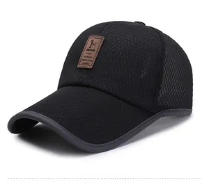 Detail of breathable black mesh baseball cap featuring a premium brown leather logo patch
