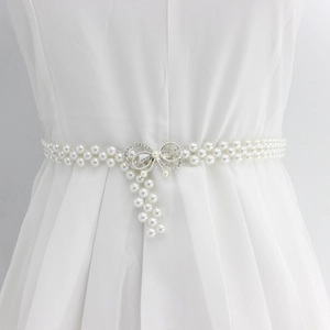 Elegant white pearl waist chain with rhinestone bow buckle and decorative tassels
