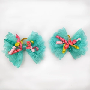 Detail of mint green lace pet hair bows with colorful curly ribbons and elastic bands