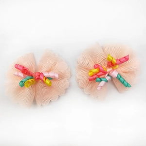 Detail of pink lace pet hair bows with colorful spiral ribbons for dogs and cats