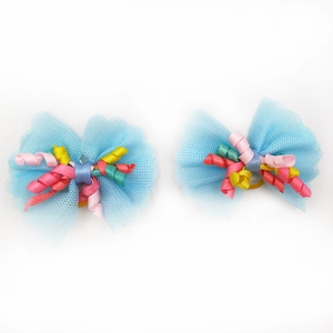 Close-up of blue lace mesh dog hair bows with colorful ribbons and yellow elastics