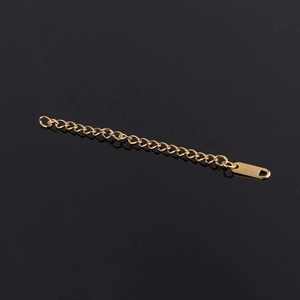 Detail of a 6cm golden stainless steel extension chain with O-rings and metal tag